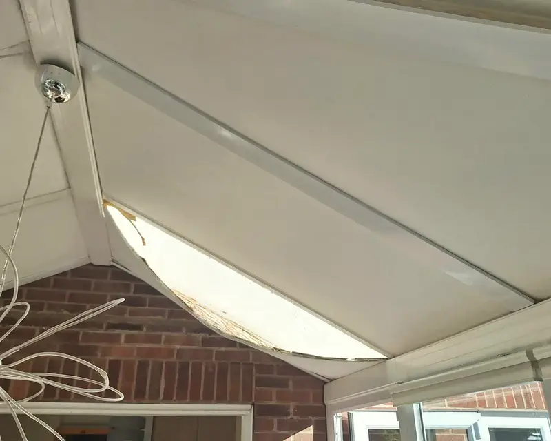 Close up of a failed polycarbonate sheet on a conservatory roof