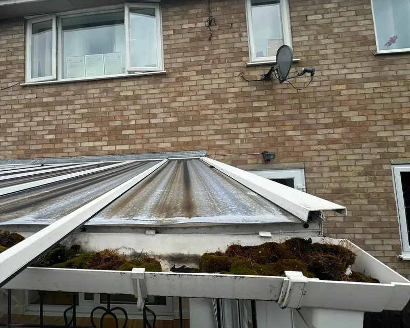 Mossy polycarbonate conservatory roof and gutter