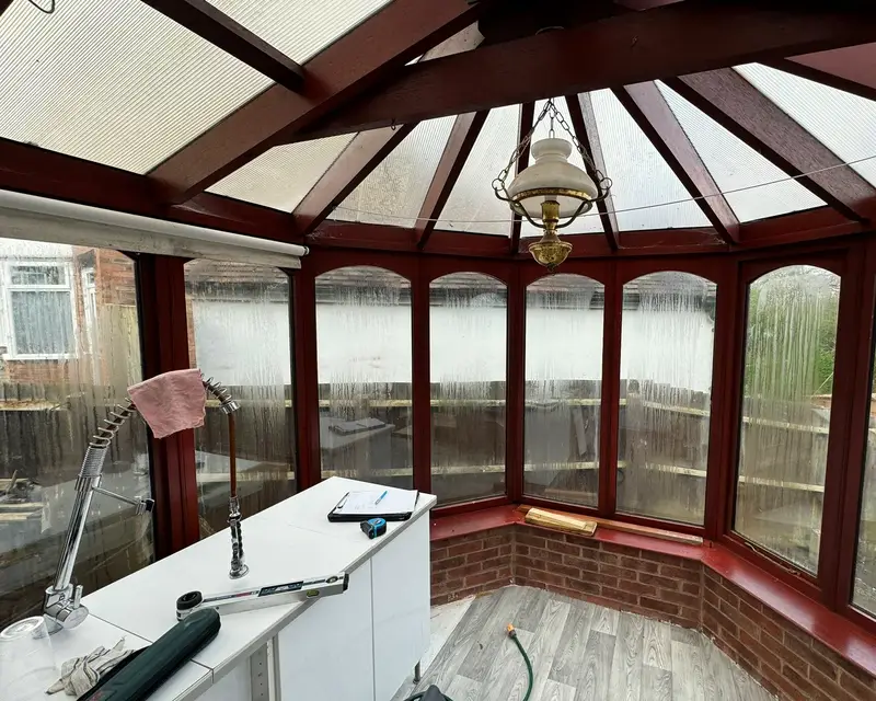 Rosewood frame conservatory with a polycarbonate roof inside