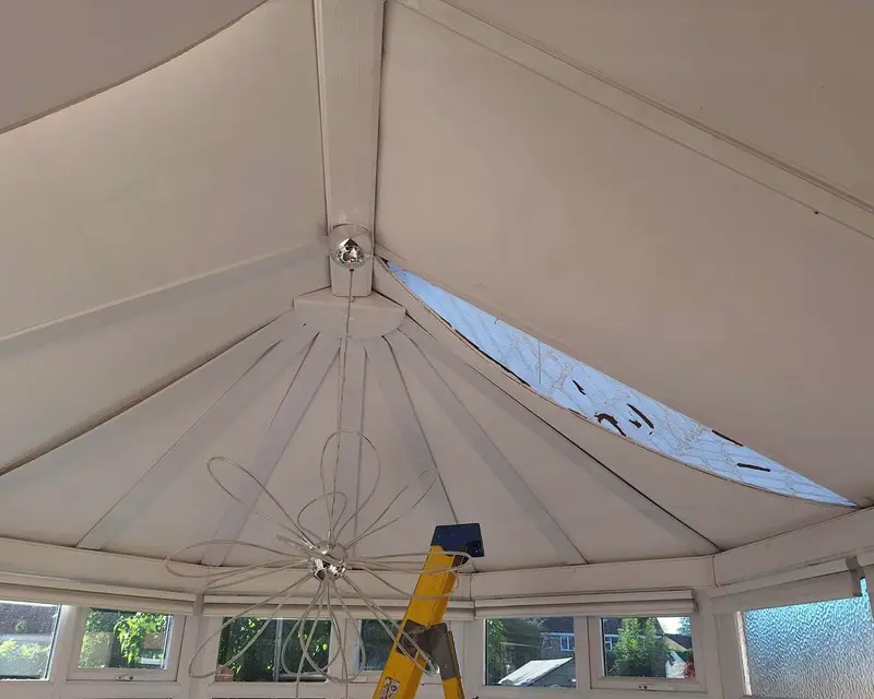 Split polycarbonate roof sheet seen from inside a conservatory