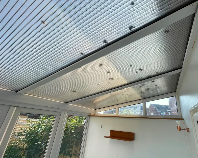 Dirty polycarbonate ceiling of a lean-to conservatory from inside