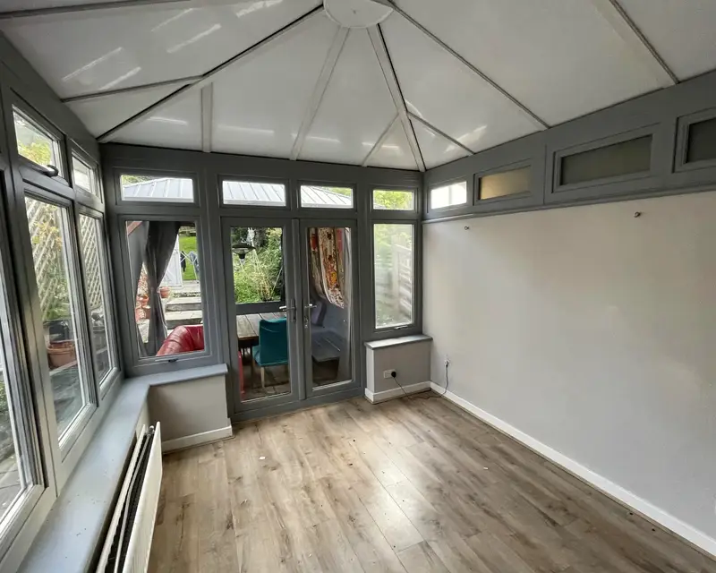 Empty conservatory with a solid panel ceiling after fitting