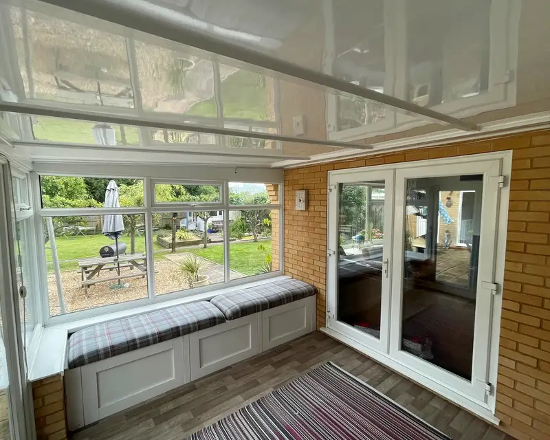 Insulated panel ceiling over French doors and a rug