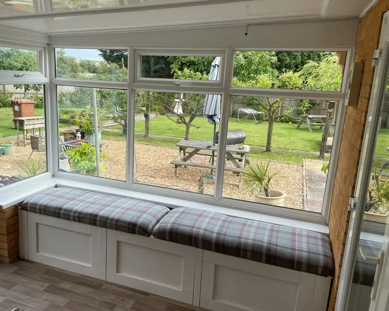 Garden view from a conservatory with a panel roof