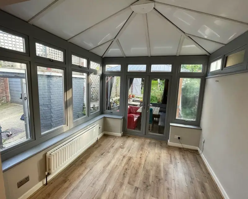 Grey framed conservatory with a white panel ceiling