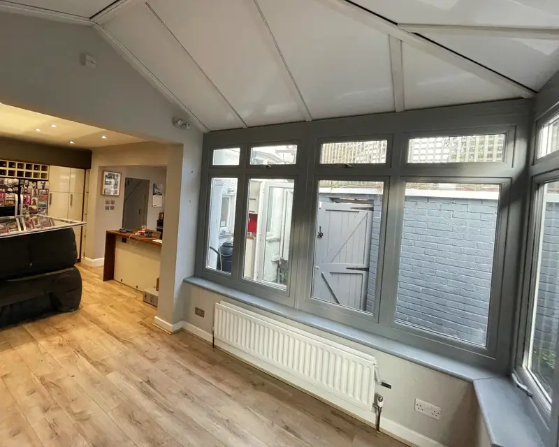 Panel roof conservatory opening into the kitchen
