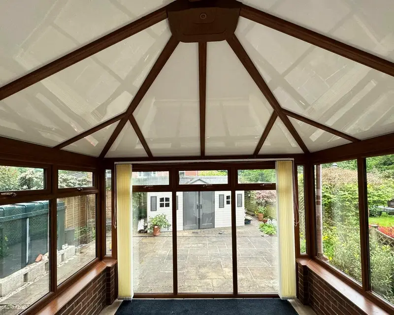 Oak effect rafters with white panel ceiling between them