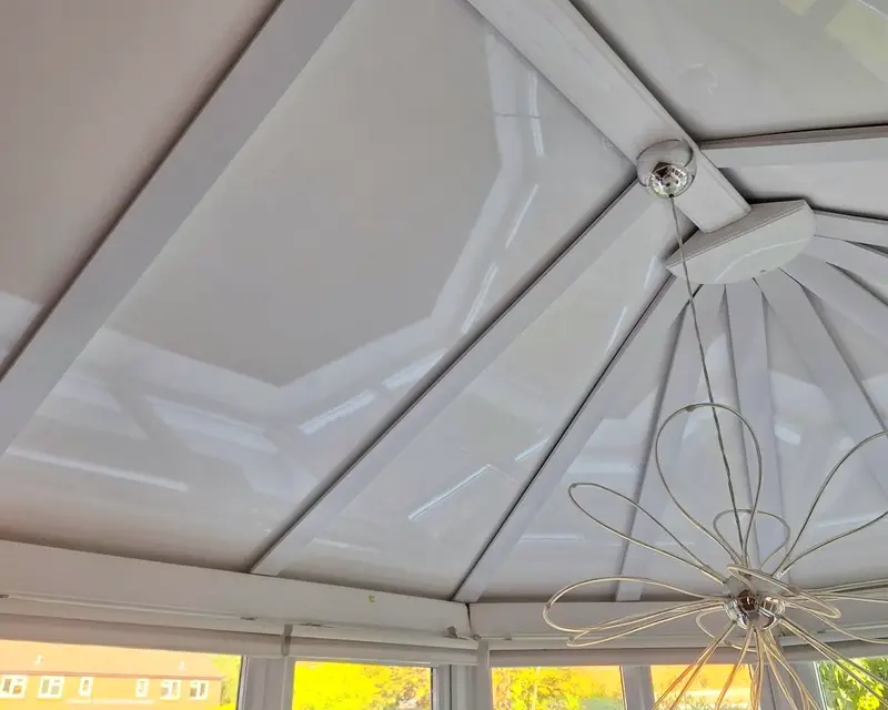 Pendant light hanging from the hub of a panel ceiling